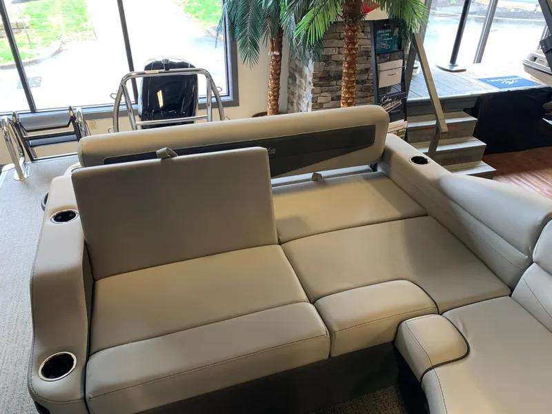 Slide: The Image of 2025 Barletta Cabrio 22U boat interior with plush seating and cup holders. - 8