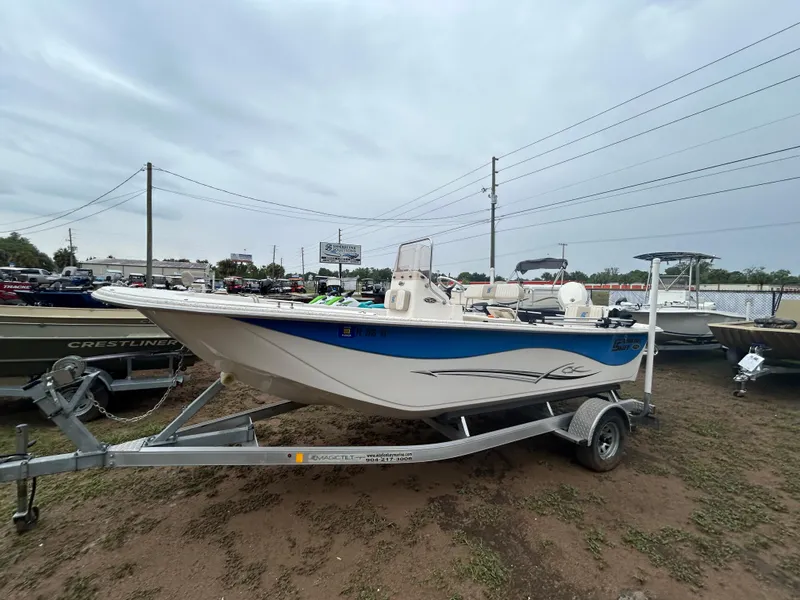 Slide: The Image of 2018 Carolina Skiff 198 DLV boat on trailer, parked outdoors. - 1