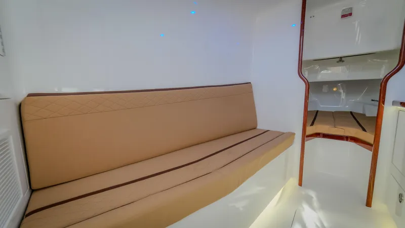 Slide: The Image of 2024 Maverick Yachts Costa Rica 36 Walkaround interior with beige seating and modern design. - 20