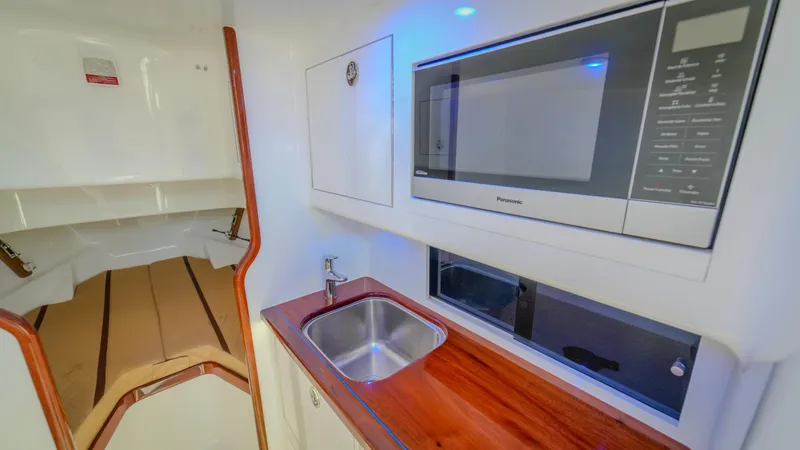 Slide: The Image of 2024 Maverick Yachts Costa Rica 36 Walkaround interior with kitchenette and sleeping area. - 22