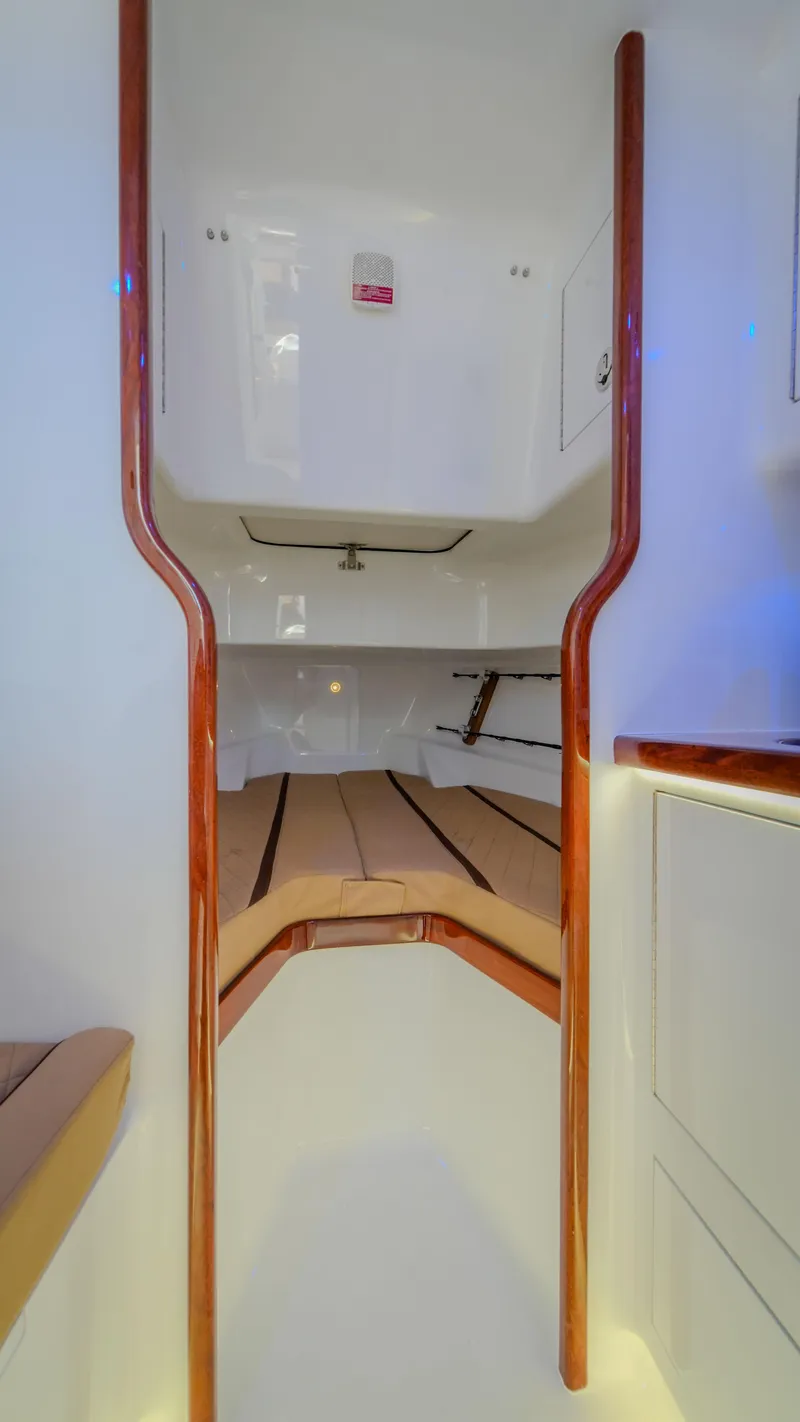 Slide: The Image of 2024 Maverick Yachts Costa Rica 36 Walkaround interior cabin with wooden accents. - 23
