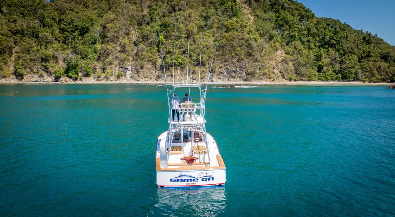 Slide: The Image of 2024 Maverick Yachts Costa Rica 36 Walkaround in serene blue waters near lush coastline. - 4