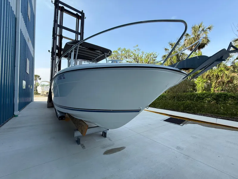 Slide: The Image of 2021 Jeanneau Leader 7.5 CC boat on a lift, outdoors, with clear blue sky. - 10