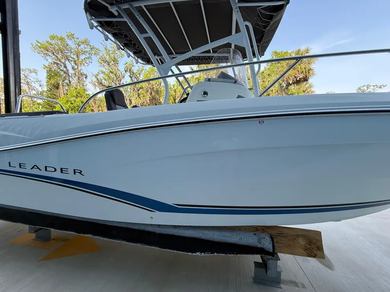 Slide: The Image of 2021 Jeanneau Leader 7.5 CC boat with sleek design and canopy, docked outdoors. - 12