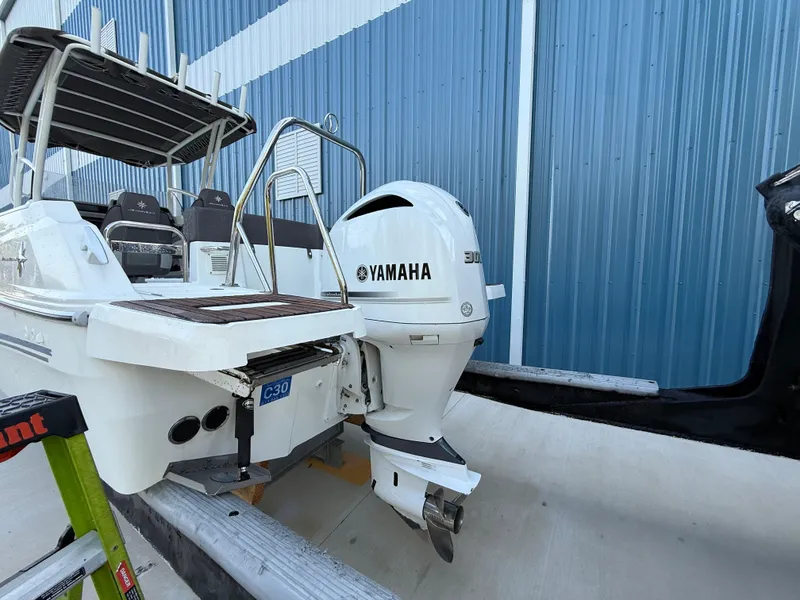 Slide: The Image of 2021 Jeanneau Leader 7.5 CC boat with Yamaha engine, docked near blue building. - 19