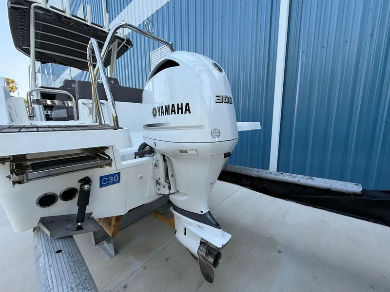 Slide: The Image of 2021 Jeanneau Leader 7.5 CC with Yamaha 300 outboard motor, docked near blue building. - 22