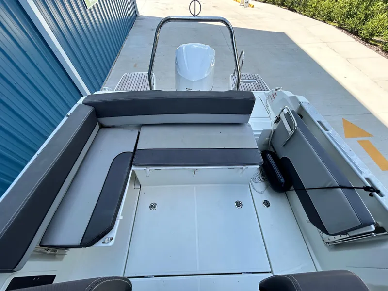 Slide: The Image of 2021 Jeanneau Leader 7.5 CC boat interior with gray seating and spacious deck. - 26