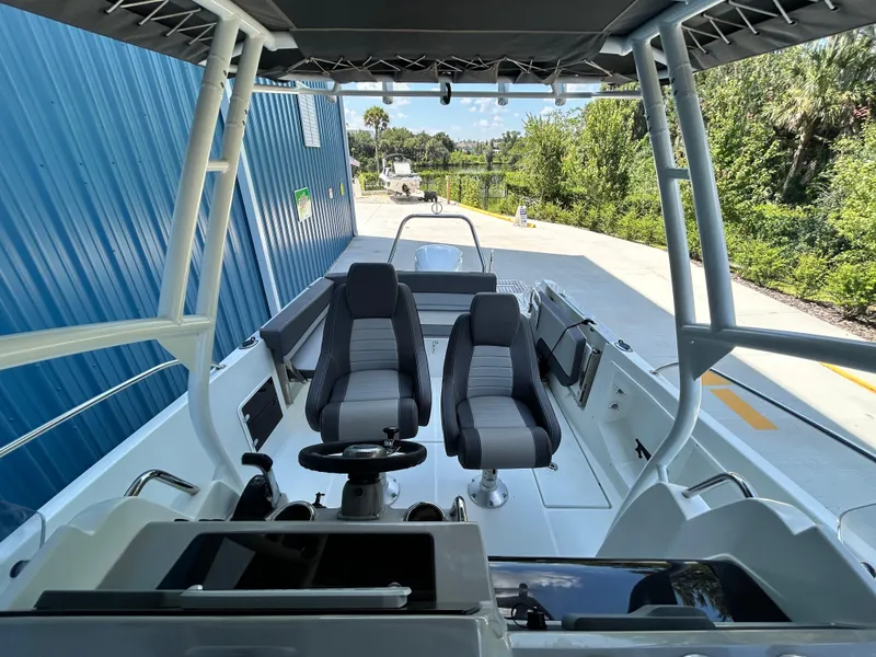 Slide: The Image of 2021 Jeanneau Leader 7.5 CC boat interior with dual seats and steering console. - 27