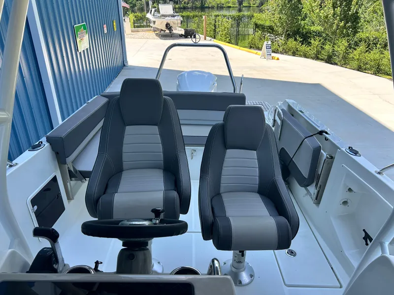 Slide: The Image of 2021 Jeanneau Leader 7.5 CC boat interior with dual seats and steering wheel. - 28