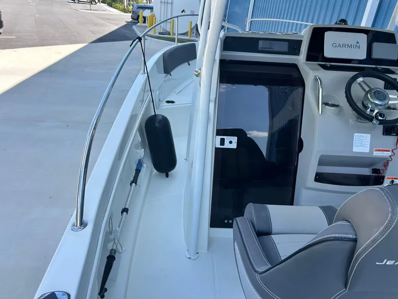 Slide: The Image of 2021 Jeanneau Leader 7.5 CC boat interior with steering wheel and Garmin display. - 30