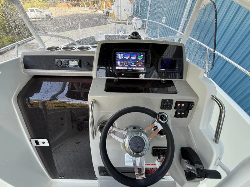 Slide: The Image of 2021 Jeanneau Leader 7.5 CC boat dashboard with steering wheel and navigation display. - 34