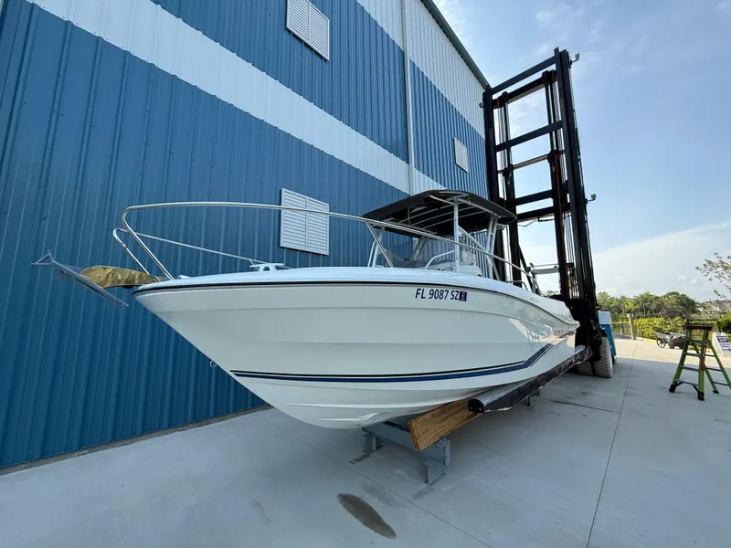 Slide: The Image of 2021 Jeanneau Leader 7.5 CC boat on dry dock near blue warehouse. - 5