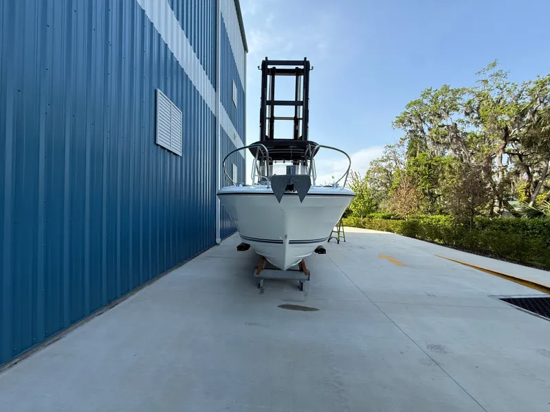 Slide: The Image of 2021 Jeanneau Leader 7.5 CC boat outside a blue warehouse. - 7