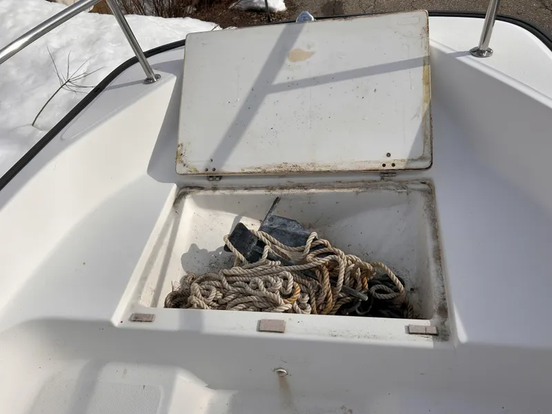 Slide: The Image of Open storage compartment on 1998 Boston Whaler 13 Sport boat with rope and anchor. - 10