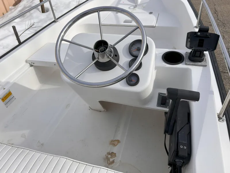 Slide: The Image of 1998 Boston Whaler 13 Sport boat interior with steering wheel and controls. - 15