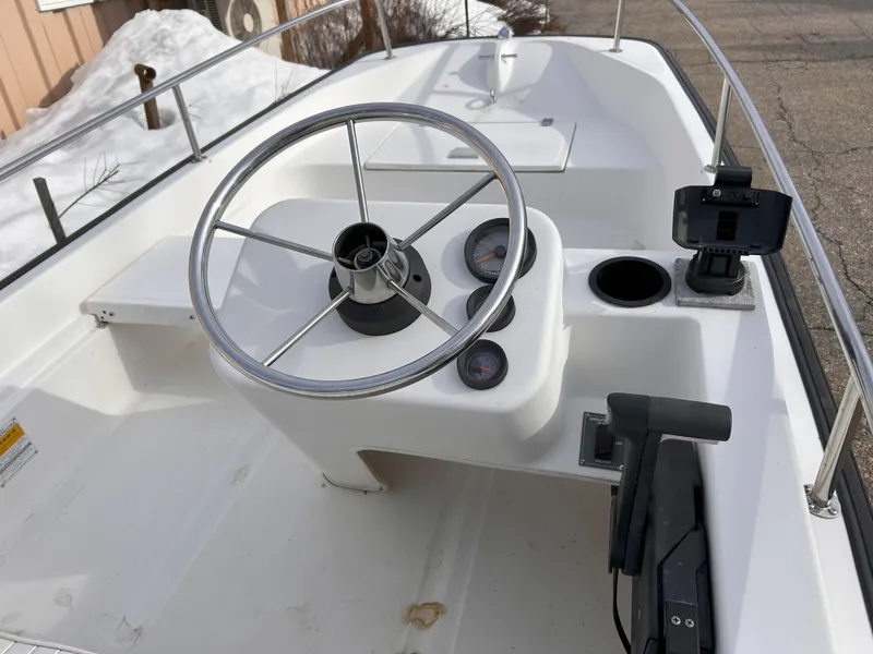 Slide: The Image of 1998 Boston Whaler 13 Sport boat dashboard with steering wheel and gauges. - 16