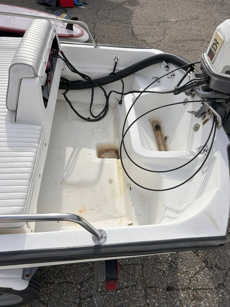 Slide: The Image of 1998 Boston Whaler 13 Sport boat interior with motor and seating. - 18