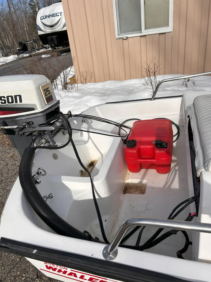 Slide: The Image of 1998 Boston Whaler 13 Sport boat with outboard motor and red fuel tank. - 20