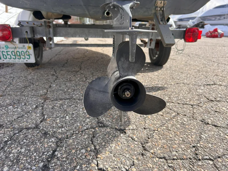 Slide: The Image of 1998 Boston Whaler 13 Sport boat propeller on trailer, close-up view. - 23