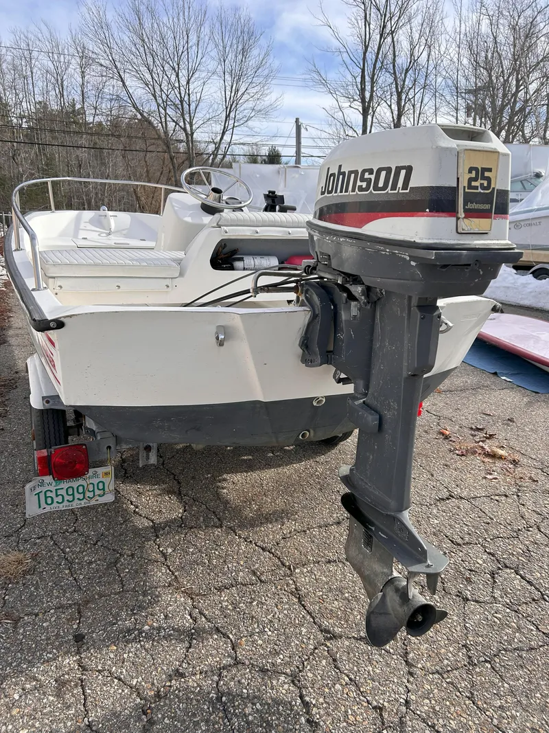 Slide: The Image of 1998 Boston Whaler 13 Sport boat with Johnson 25 outboard motor, parked outdoors. - 26