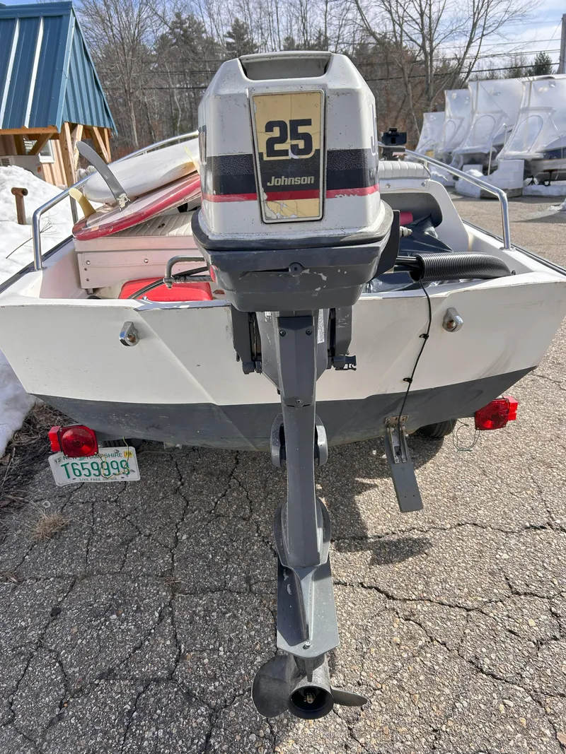 Slide: The Image of 1998 Boston Whaler 13 Sport with Johnson 25 outboard motor, parked outdoors. - 29