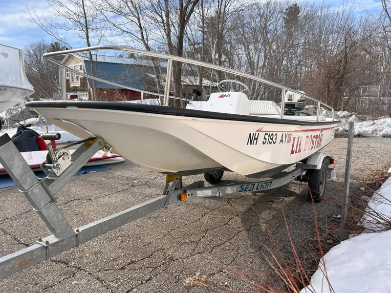 Slide: The Image of 1998 Boston Whaler 13 Sport boat on trailer, parked outdoors in winter setting. - 4
