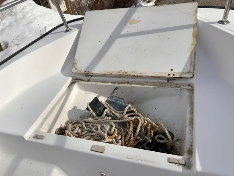 Slide: The Image of Open storage compartment on a 1998 Boston Whaler 13 Sport with ropes and anchor. - 9