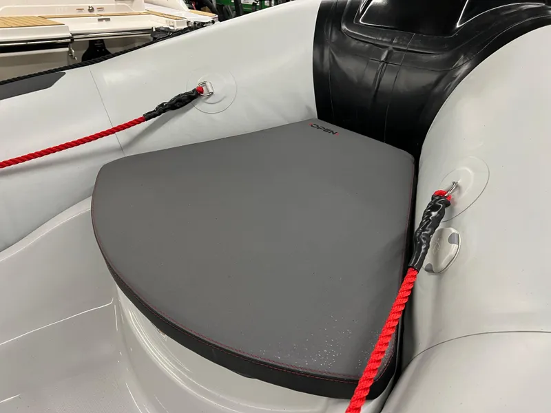 Slide: The Image of 2023 Zodiac Open 4.2 boat interior with red ropes and cushioned seating. - 11