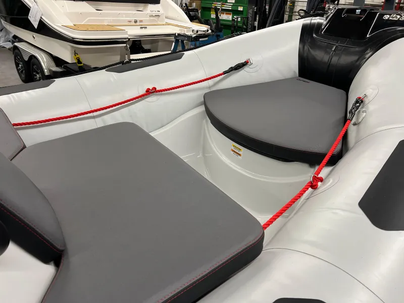 Slide: The Image of 2023 Zodiac Open 4.2 boat interior with gray seating and red ropes. - 8