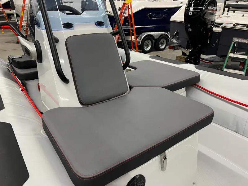 Slide: The Image of 2023 Zodiac Open 4.2 boat interior with gray seating and modern design. - 9