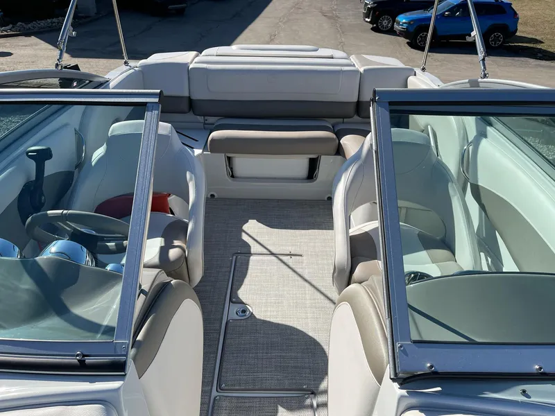Slide: The Image of 2020 Crownline 205 SS boat interior with seating and steering wheel. - 17