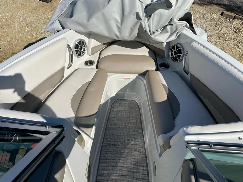 Slide: The Image of 2020 Crownline 205 SS boat interior with cushioned seating and speakers. - 18