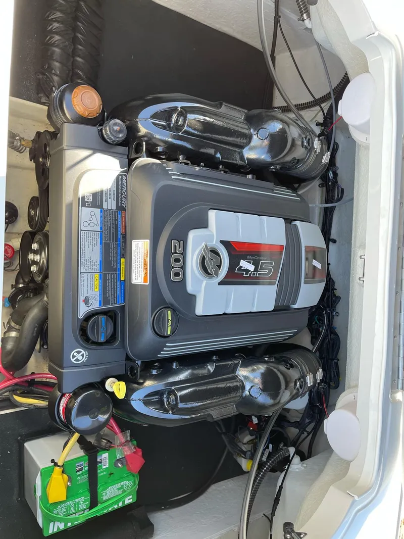 Slide: The Image of 2020 Crownline 205 SS engine compartment with visible components and wiring. - 20