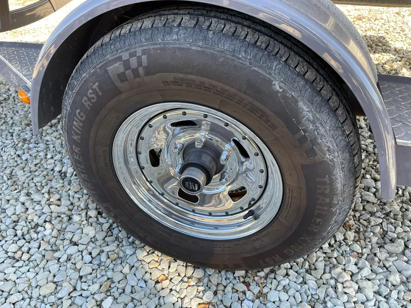 Slide: The Image of Trailer wheel of a 2020 Crownline 205 SS on gravel surface. - 23