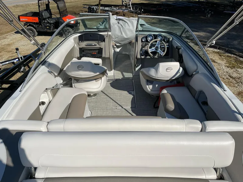 Slide: The Image of 2020 Crownline 205 SS boat interior with seating, steering wheel, and dashboard. - 5