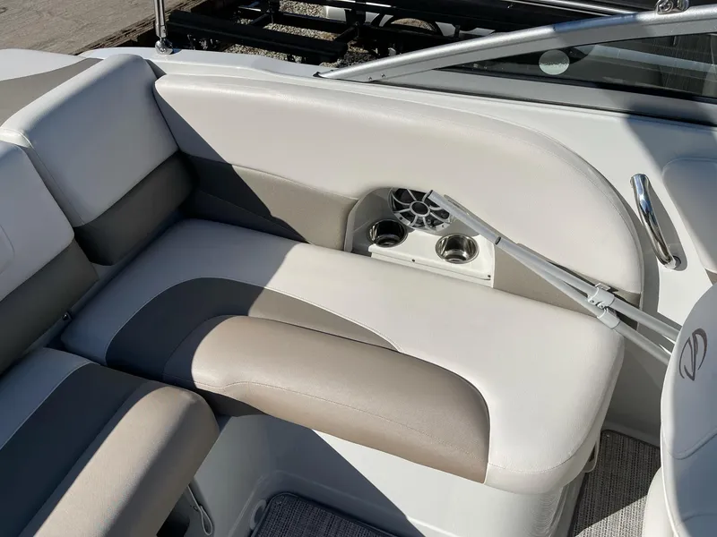 Slide: The Image of 2020 Crownline 205 SS boat interior with beige seating and cup holders. - 6