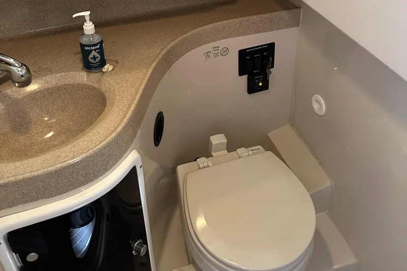Slide: The Image of 2015 Wellcraft 290 Coastal boat bathroom with sink and toilet. - 17