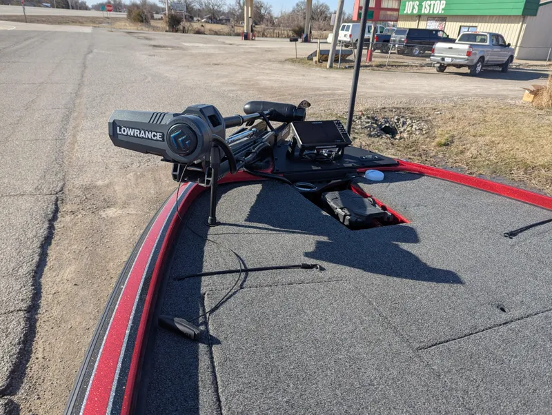 Slide: The Image of 2023 Nitro Z20 boat with Lowrance equipment on deck, parked near a roadside. - 13