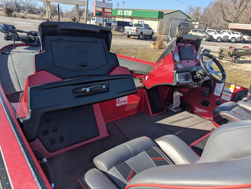 Slide: The Image of 2023 Nitro Z20 boat interior with red and black seating, dashboard, and storage compartments. - 14