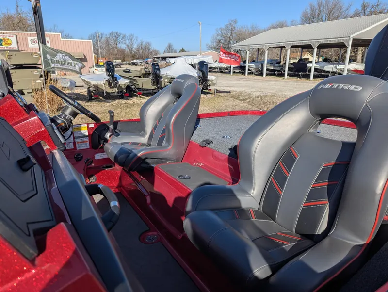 Slide: The Image of 2023 Nitro Z20 boat interior with sleek black and red seats, outdoor showroom setting. - 15
