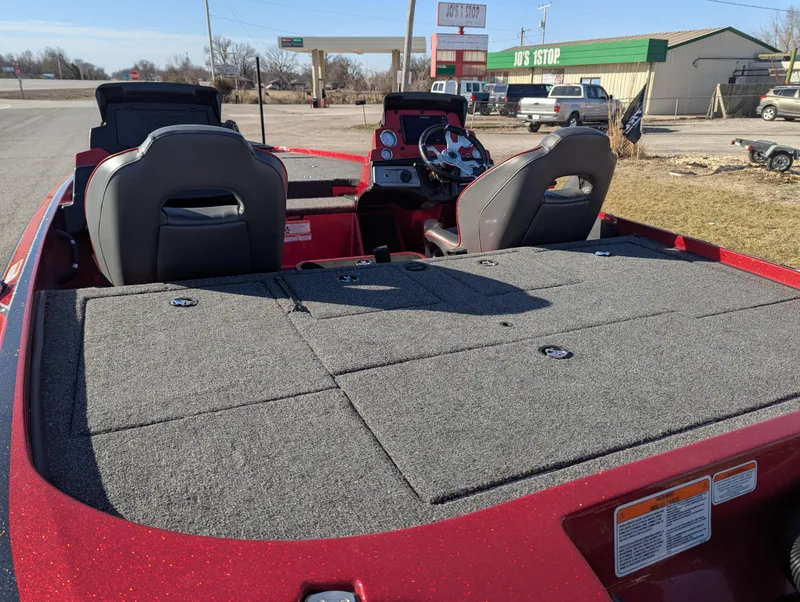 Slide: The Image of 2023 Nitro Z20 boat with spacious deck and dual seats in a parking area. - 16