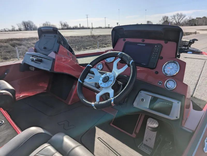 Slide: The Image of 2023 Nitro Z20 boat cockpit with steering wheel, gauges, and navigation system. - 17