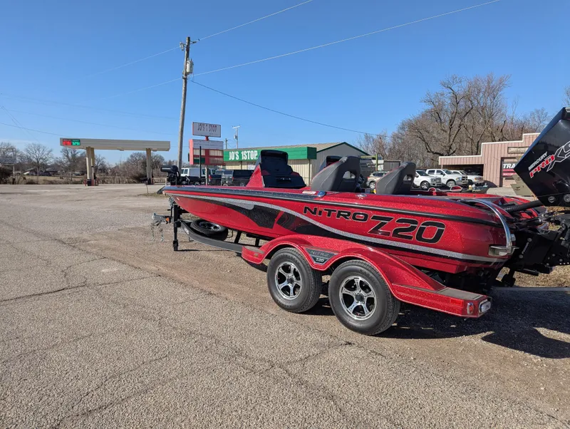 Slide: The Image of 2023 Nitro Z20 boat on trailer in parking lot, sunny day. - 3