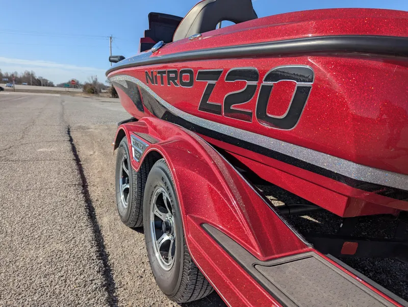 Slide: The Image of Red 2023 Nitro Z20 boat on trailer, parked on roadside. - 4