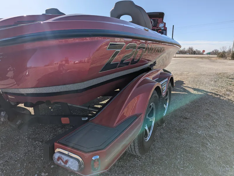 Slide: The Image of 2023 Nitro Z20 boat on trailer, red color, parked outdoors. - 7