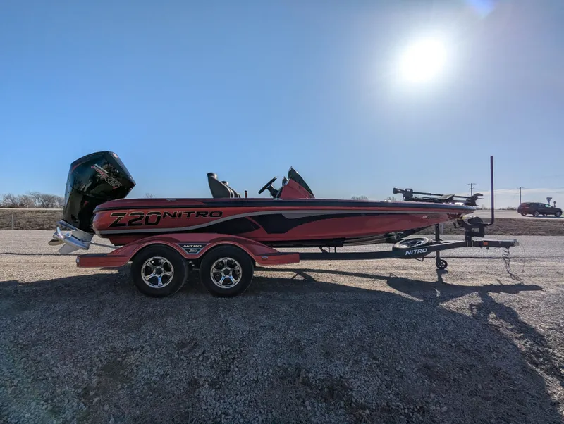 Slide: The Image of 2023 Nitro Z20 boat on trailer under clear blue sky. - 9