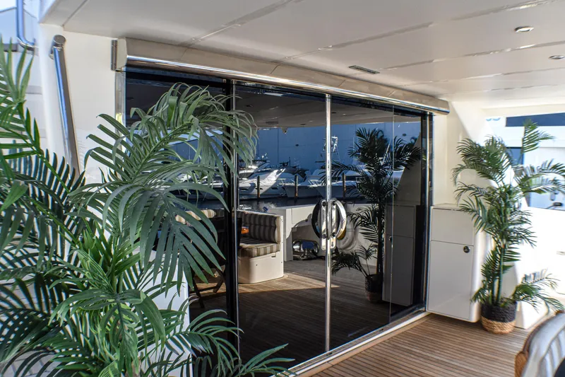 Slide: The Image of Luxurious 2006 Johnson Country Kitchen yacht interior with glass doors and tropical plants. - 10
