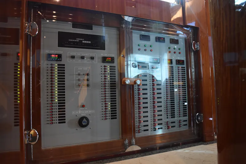Slide: The Image of Electrical control panel in a 2006 Johnson Country Kitchen yacht, featuring switches and indicators. - 11