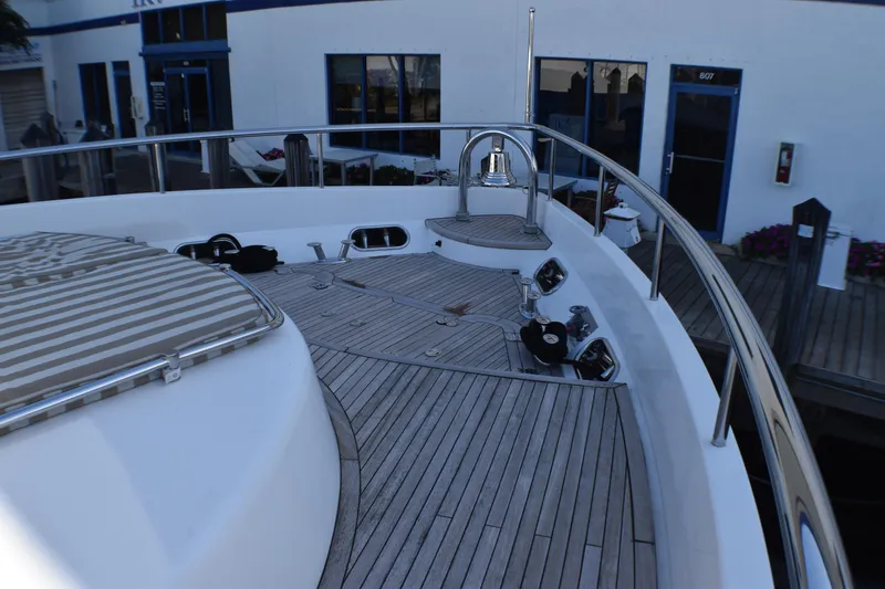 Slide: The Image of Deck of 2006 Johnson Country Kitchen yacht with wooden flooring and metal railings. - 13