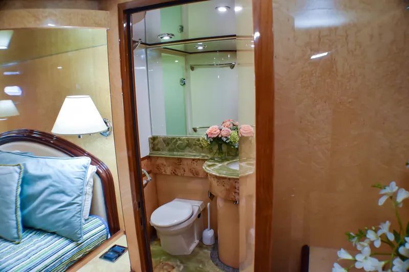 Slide: The Image of Luxurious yacht bathroom with marble countertop, floral arrangement, and cozy adjacent bedroom. Johnson Country Kitchen 2006. - 18